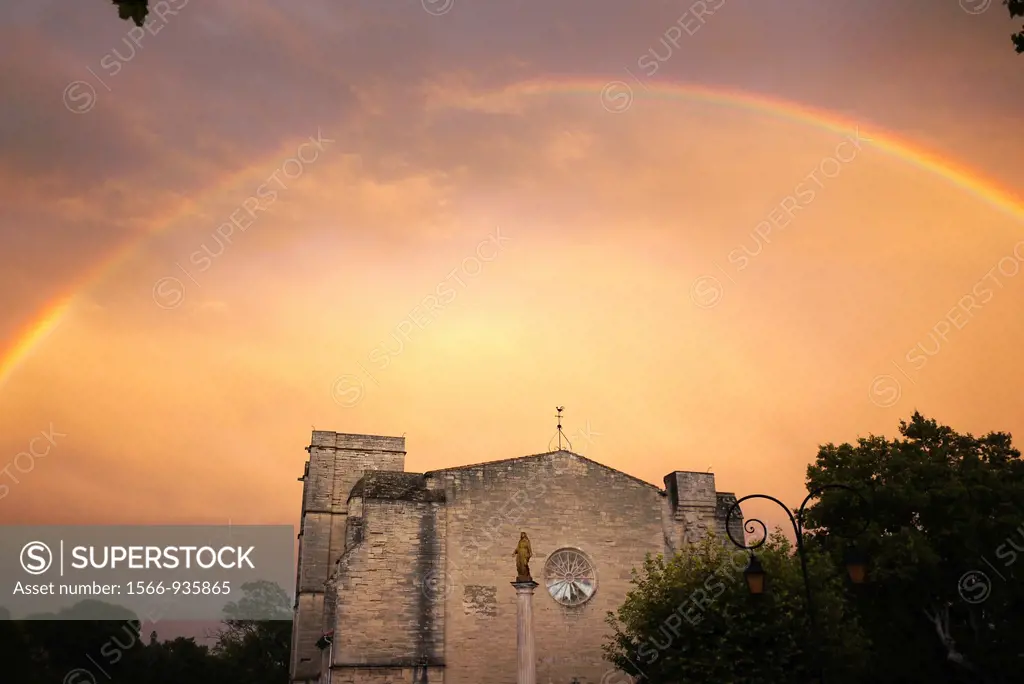 After a rainstorm a rainbow appears over the 13th century Church of St. Saturnin on the outskirts of Pezenas, France