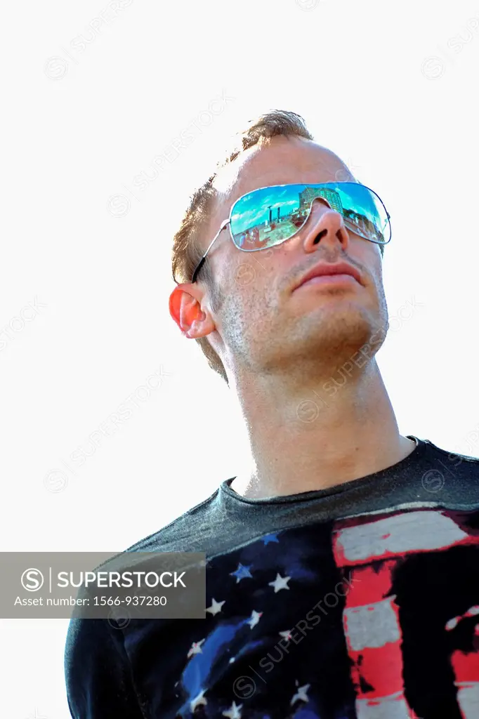 Young caucasian man, head and shoulders, with black Shirt, looking into the far distance, wearing sun glasses, Hamburg, Germany, Europe