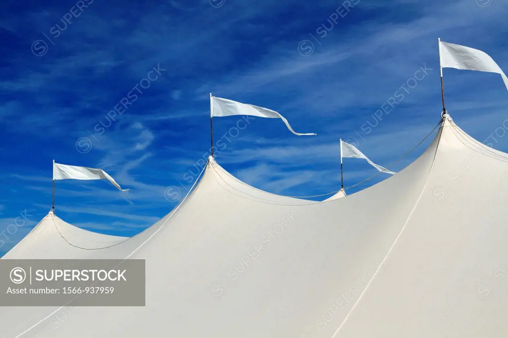 The top of a large white event tent in front of a blue sky  On the beach in Long Branch, New Jersey, USA