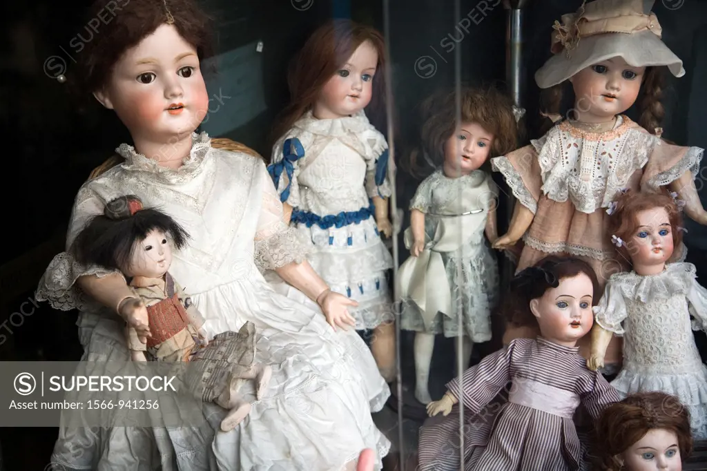 Vintage porcelain dolls exposed on a shop window, Calçada do Combro, Lisbon
