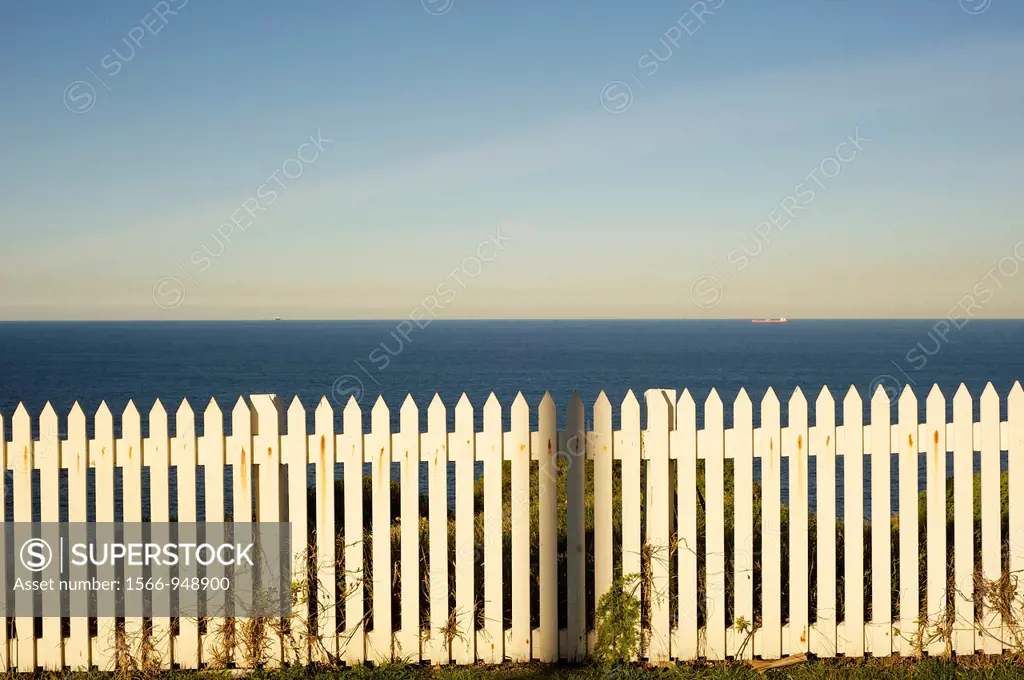 white picket fence by the sea