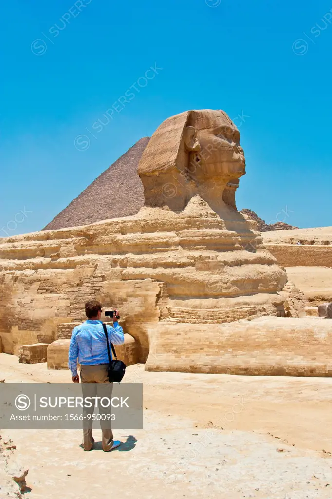 Tourist shooting video at Great Sphinx and Pyramid of Giza