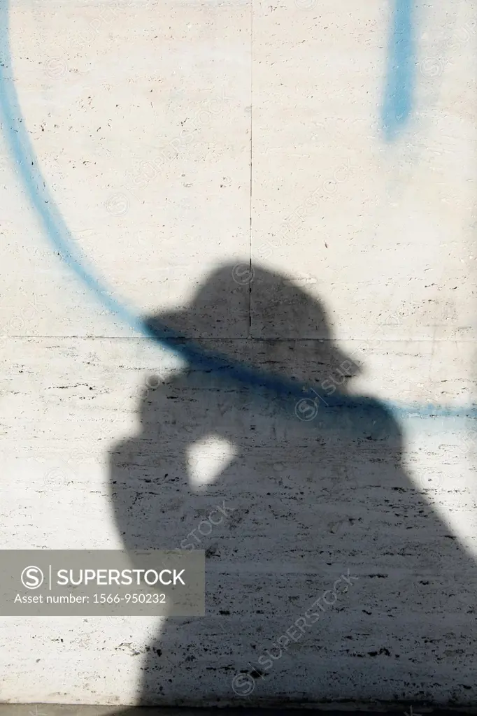 shadow of man talking on mobile phone