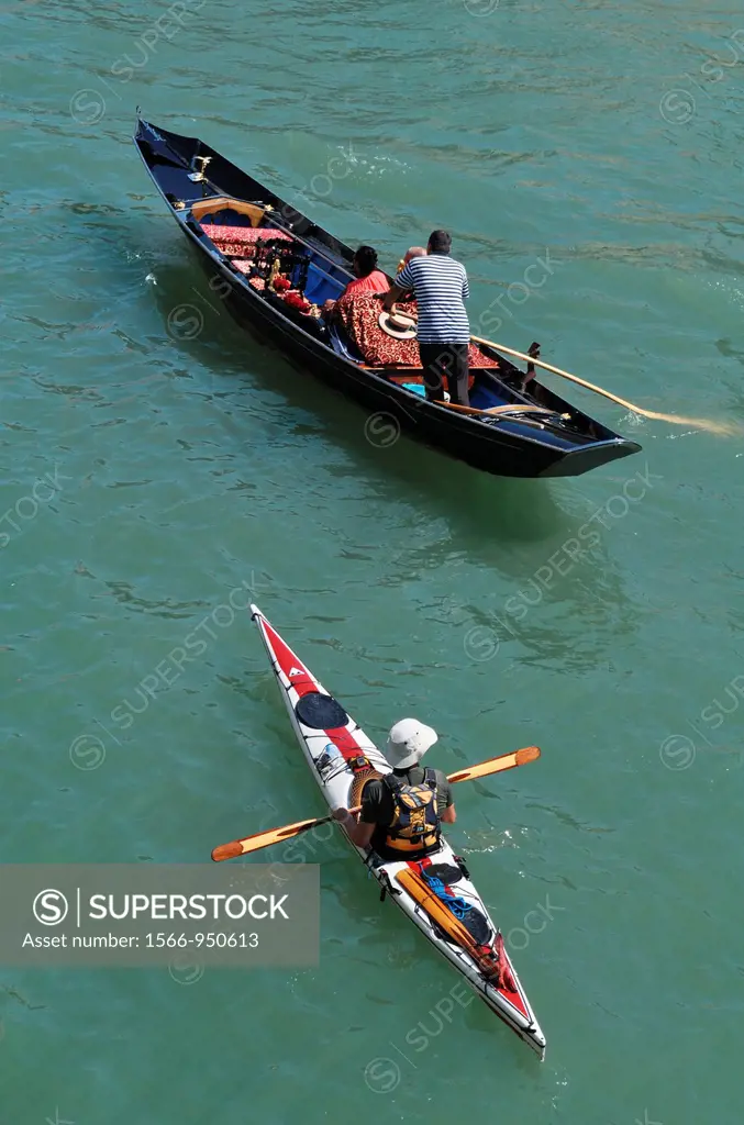 Venezia (Italy): gondola and canoe along the Canal Grande