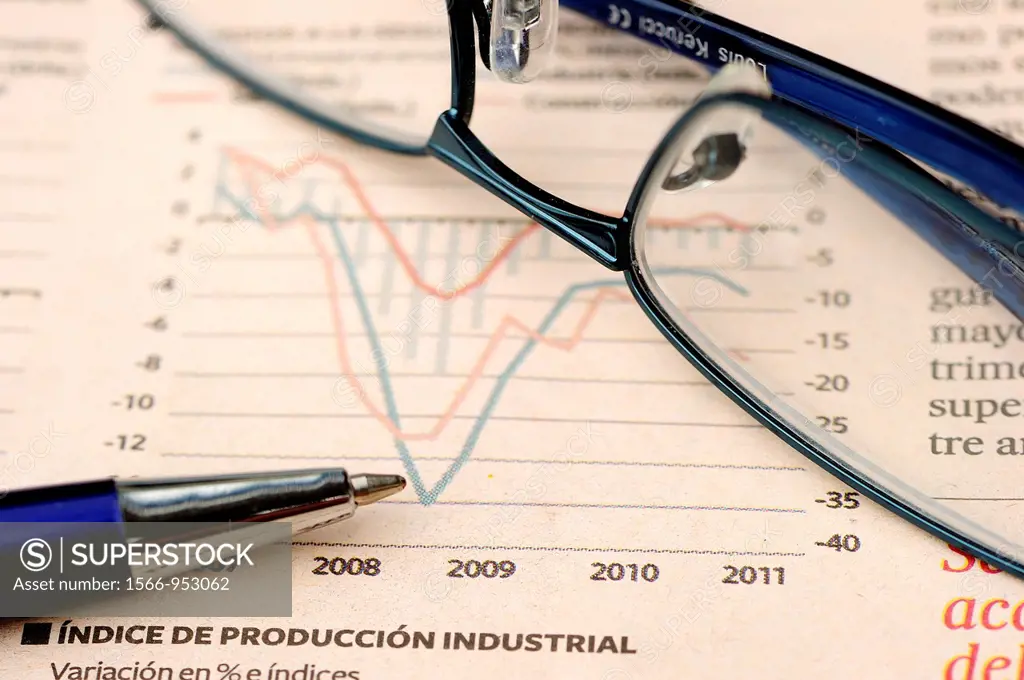 Glasses and pen on economic report