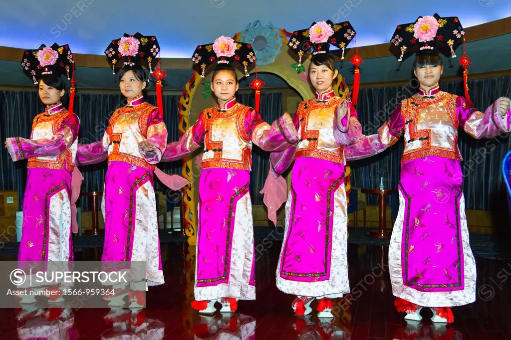 Ethnic Chinese dancers perform a cultural show on the Empress Victoria riverboat on the Yangtze River, China