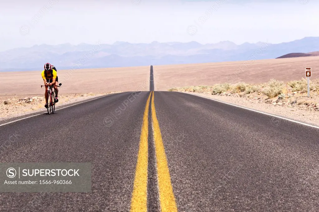 A lone cyclist rides through Death Valley National Park just before asking for a ride