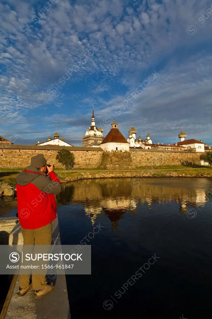 A photographer outside the Russian Orthodox Solovetsky Monastery founded in 1436 by 2 monks on Bolshoy Island, Solovetsky Island Group, White Sea, Rus...