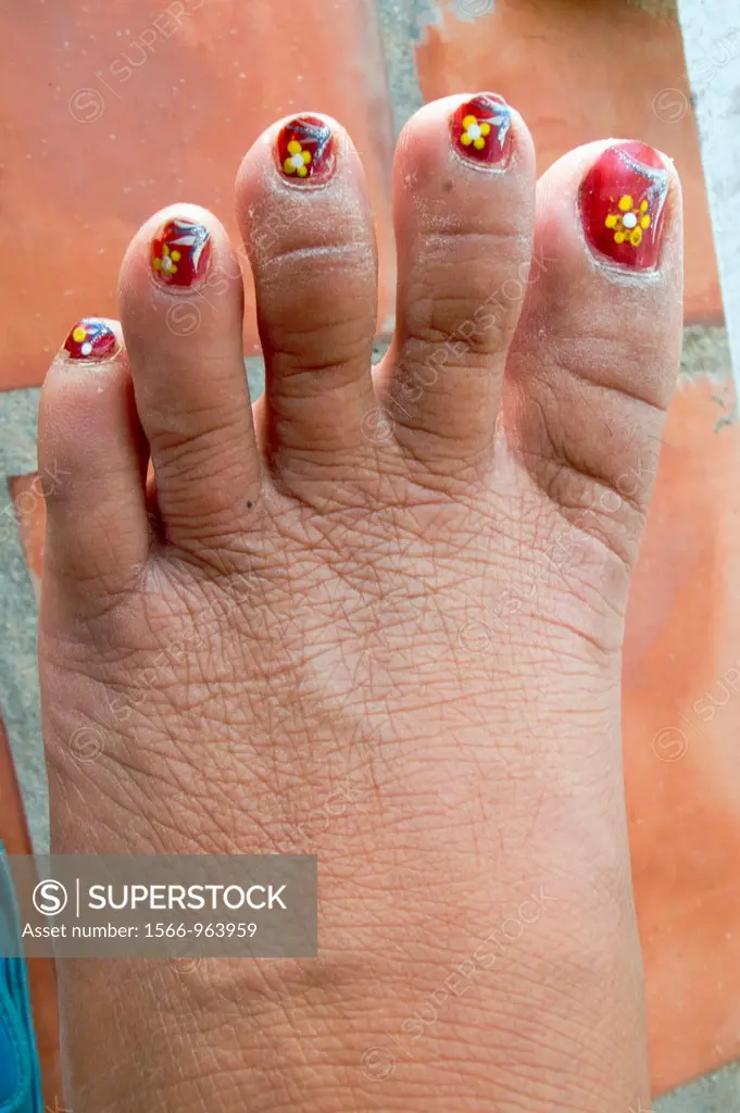 Yellow flowers painted on toes with nail varnish in Phu Quoc Island Vietnam
