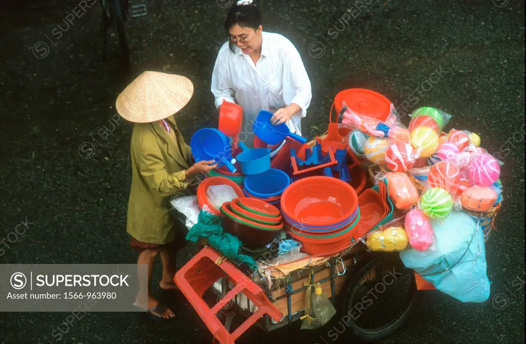 Barrow vendor sells household plastic wares Ho Chi Minh City Vietnam