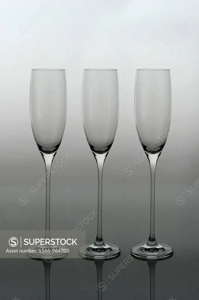 Three crystal Champagne glasses photographed backlit on vertical gradient