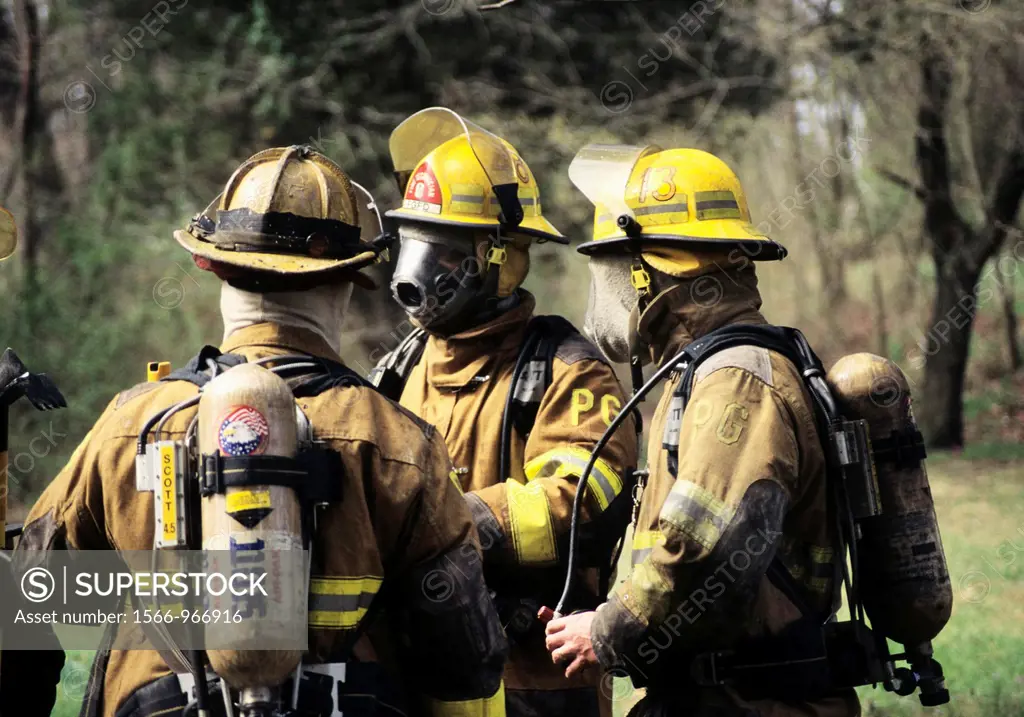 Firefighters discussing strategy at a house fire