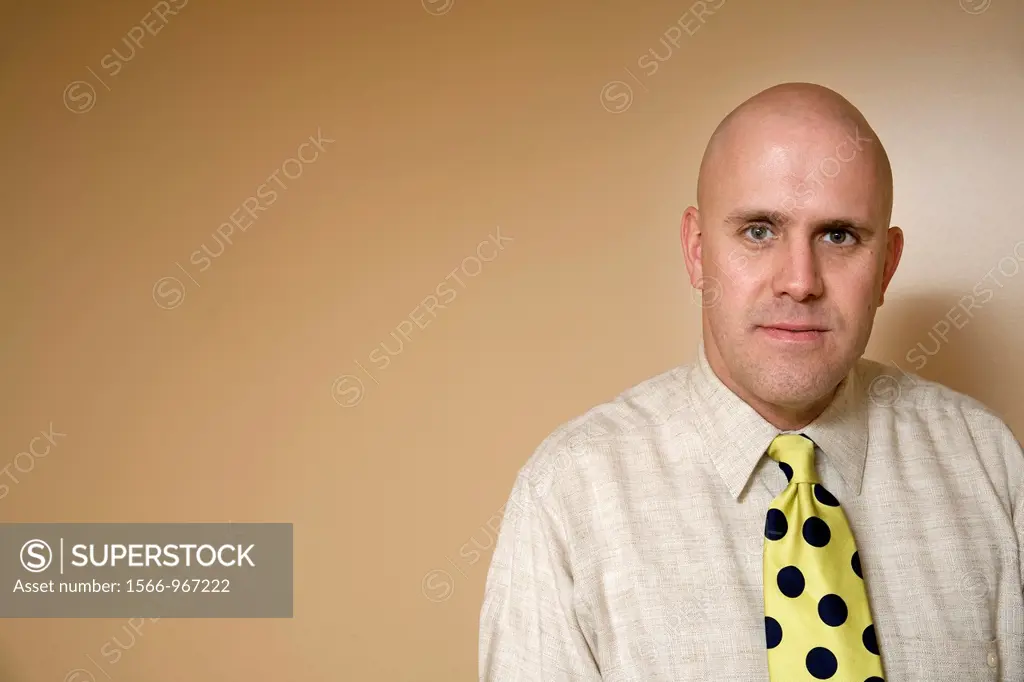 Middle-age bald man wearing a tie