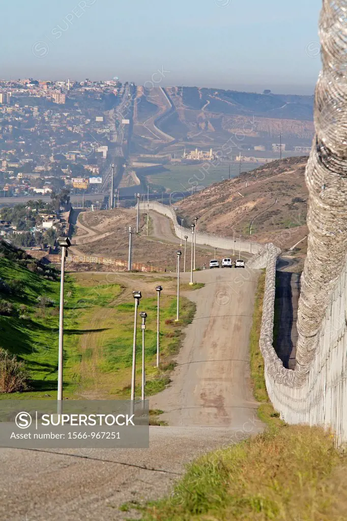 San Ysidro, California - Three U S  Border Patrol vehicles patrol the international border between the United States and Mexico  The Border Patrol´s n...