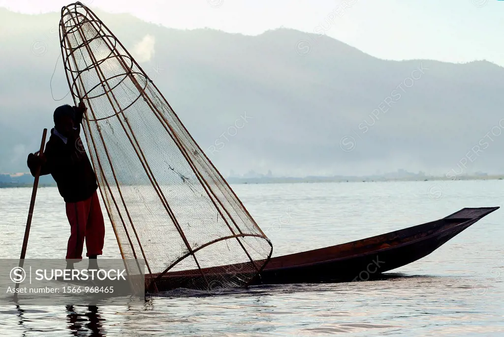 Man fishing from small boat at Inle Lake in Burma Myanmar
