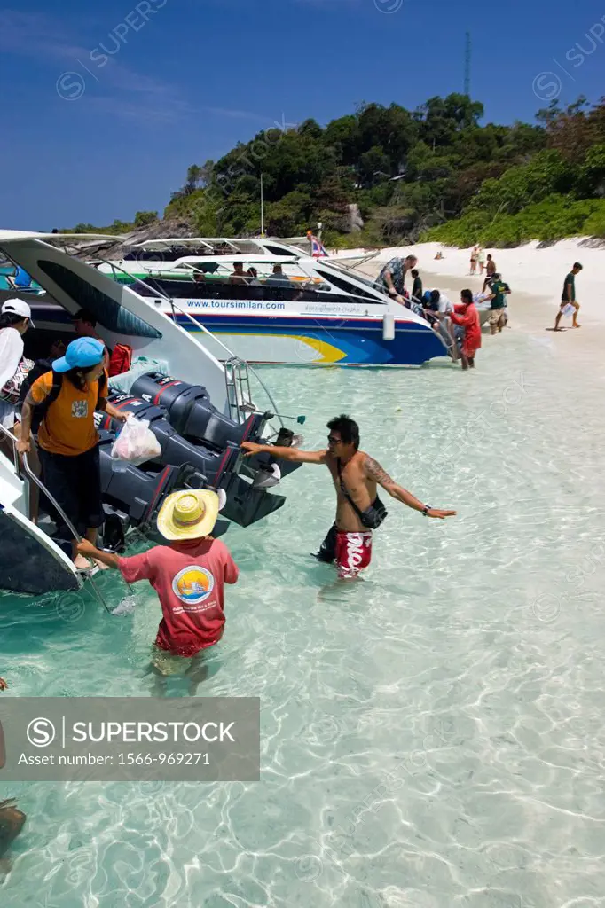 Visitors wade ashore from speed boats Similan Island Ko 8 Similan Islands Thailand