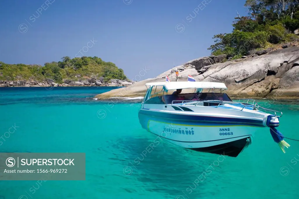Speed boat appears to hang in clear blue tropical water Similan Islands Thailand