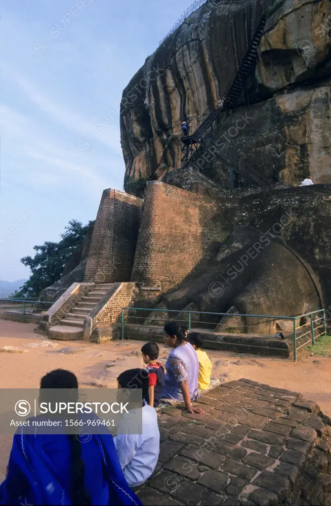 Local family sitting on Lion gate, down of Lion´s rock of old Sigiriya fortress, Sri Lanka