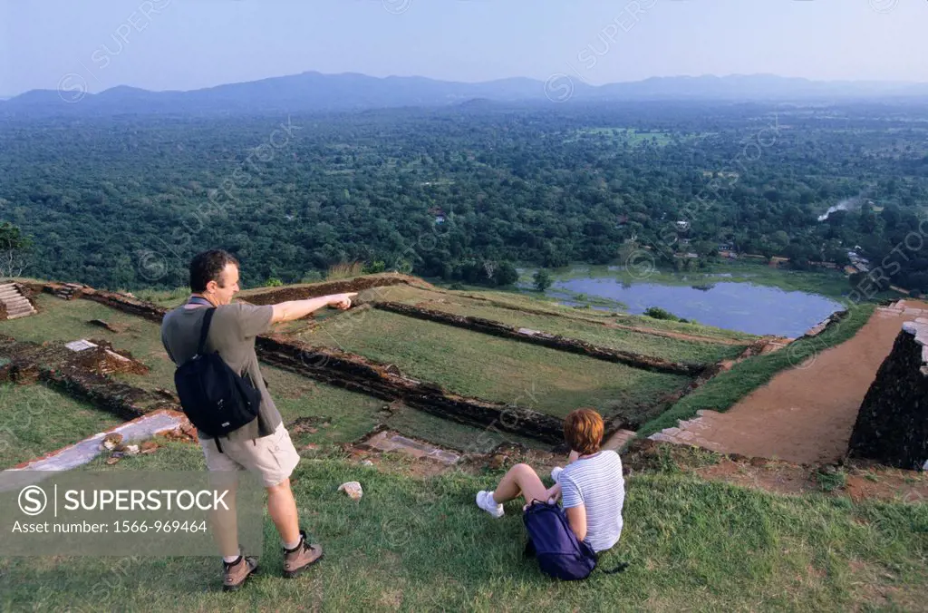 Couple tourist looking panorama on summit of old royal palace vestiges, Sigiriya Lion´s rock fortress, Sri Lanka