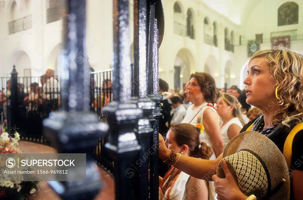 El Rocío Romería pilgrimage ,Pilgrims praying in front of the Blanca Paloma, Virgin of Rocío, Ermita del Rocío, El Rocío, Almonte, Huelva province, An...
