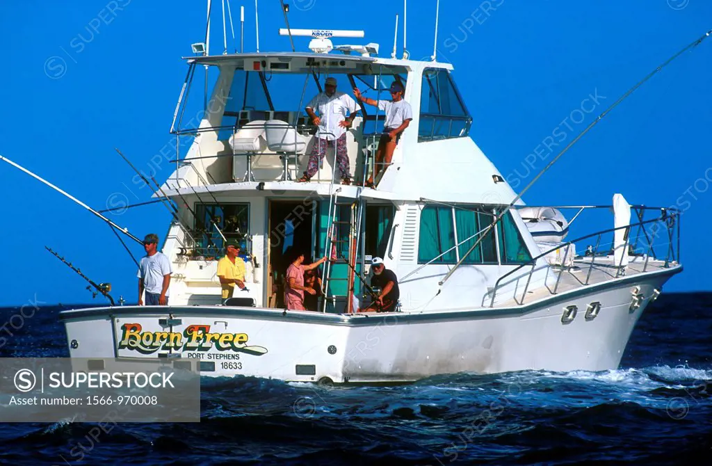 Big game fishing boat trolling near Great Barrier Reef off Cairns  Queensland Australia - SuperStock