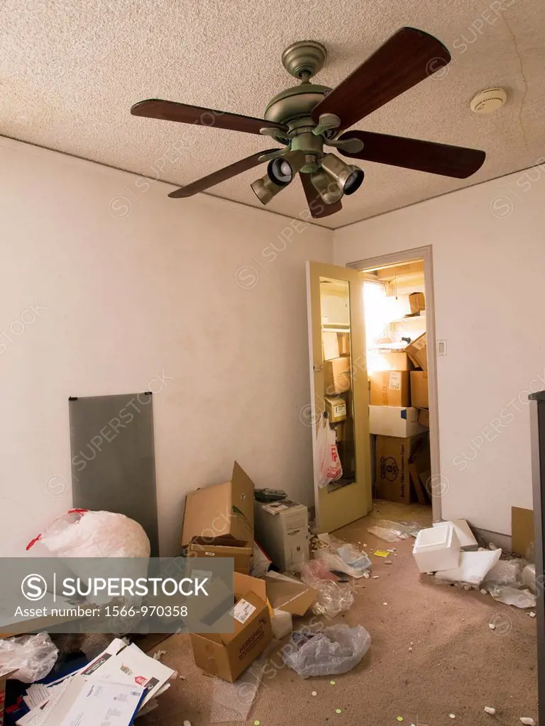 A vacant room inside a foreclosed home is littered with empty cardboard boxes, packing materials, and trash in Long Beach, California, Uniited States