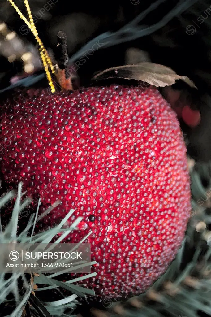 A red beaded apple ornament with effects