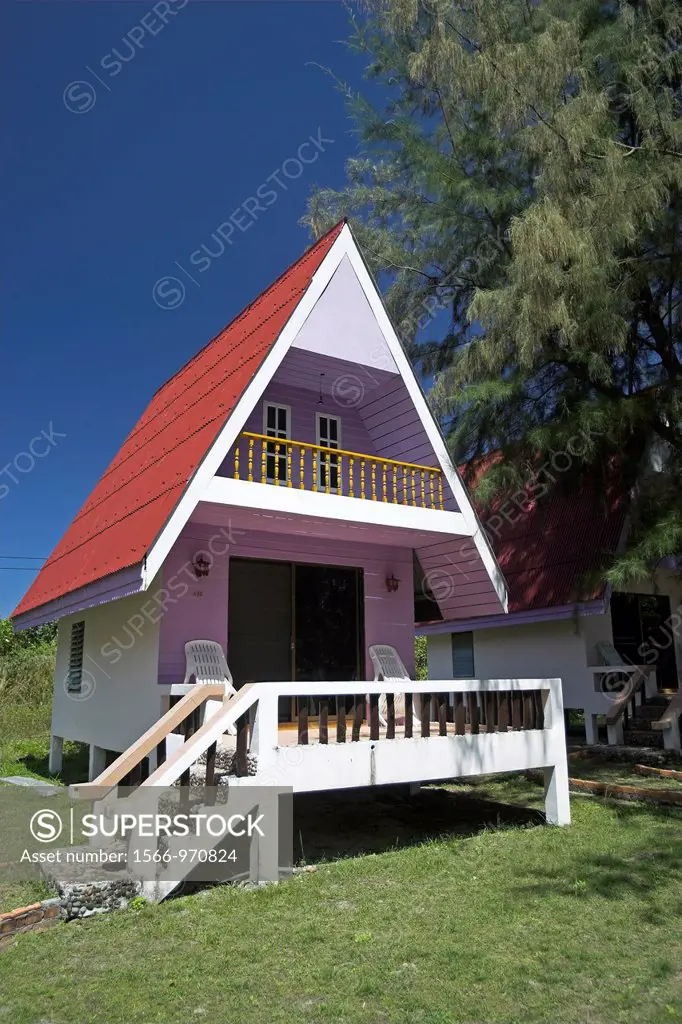 Pastel coloured red roof A frame bungalow Andaman Beach Resort Ko Jum island Thailand
