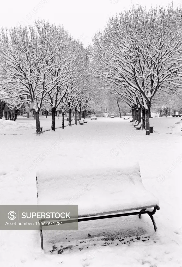 Italy, Lombardy, Crema, Public Gardens in Winter, Snow Covered Bench