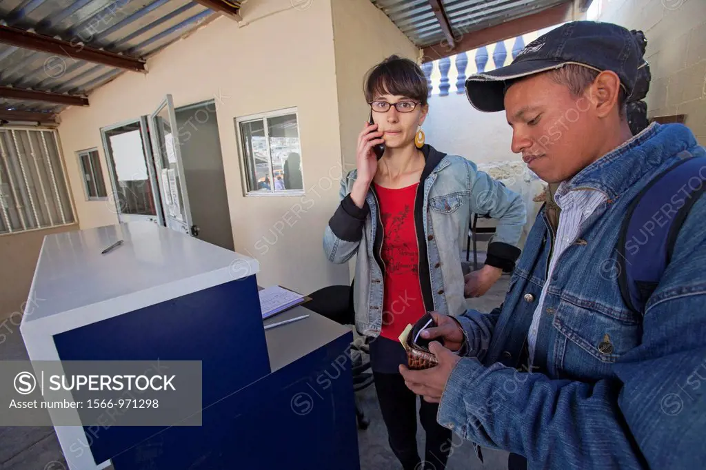 Nogales, Sonora, Mexico - Samara Rosenberg left, a volunteer from Pittsburgh, makes a phone call for a young Honduran man who was unsuccessful in cros...