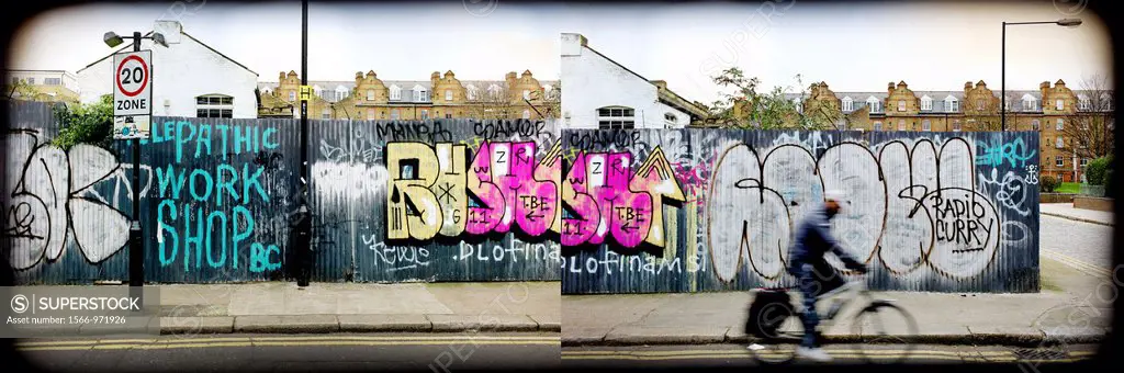 Brick Lane, East London, England, Uk. Grafitty wall and a man going on a bike