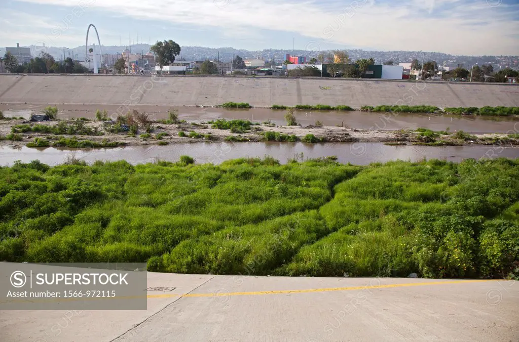 San Ysidro, California - The polluted Tijuana River as it enters the United States from Mexico  The yellow line in the foreground is the boundary betw...