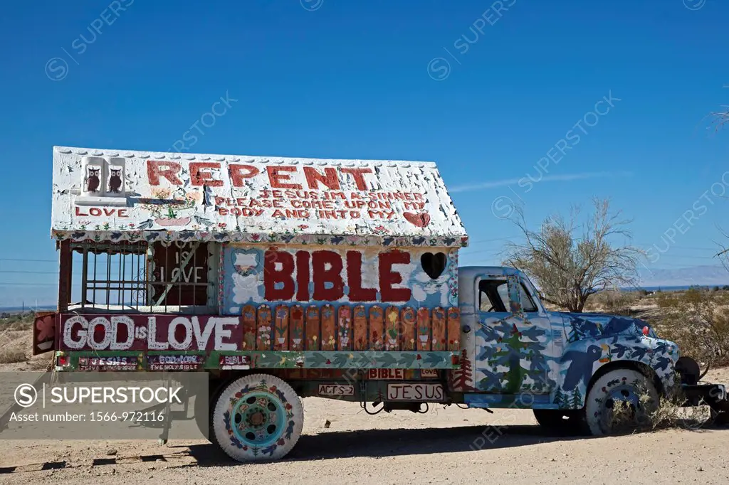 Niland, California - Salvation Mountain, a desert hillside covered with religious messages, created by Leonard Knight  An old truck decorated with rel...