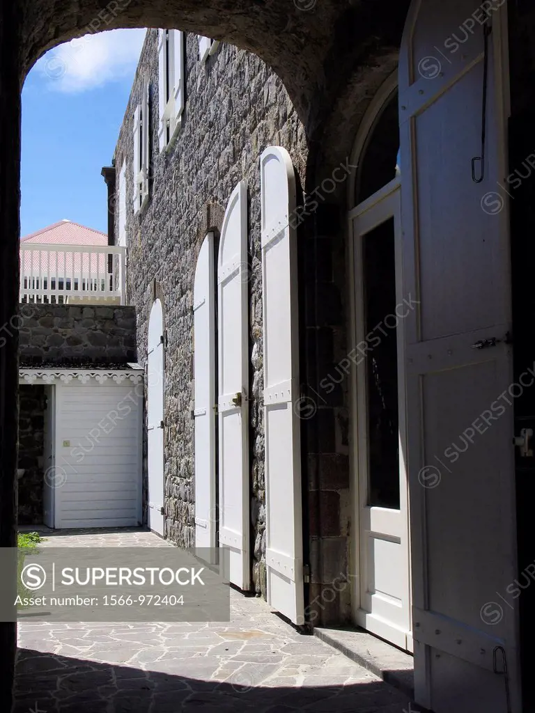 Archway and shutter doors on stone museum building Gustavia St Barts