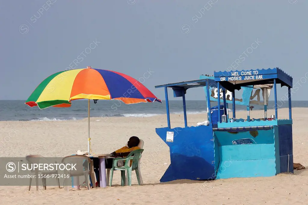 Colored umbrella and table at juice bar Palma Rima beach Kololi The Gambia