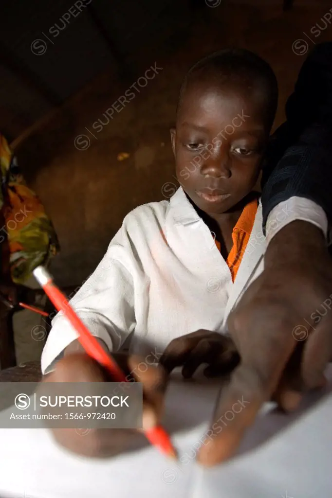 Boy concentrates as headmaster makes point primary school Berending village south of The Gambia