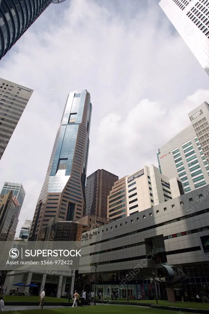 Modern tower blocks and business buildings surround lawns Raffles Place Singapore