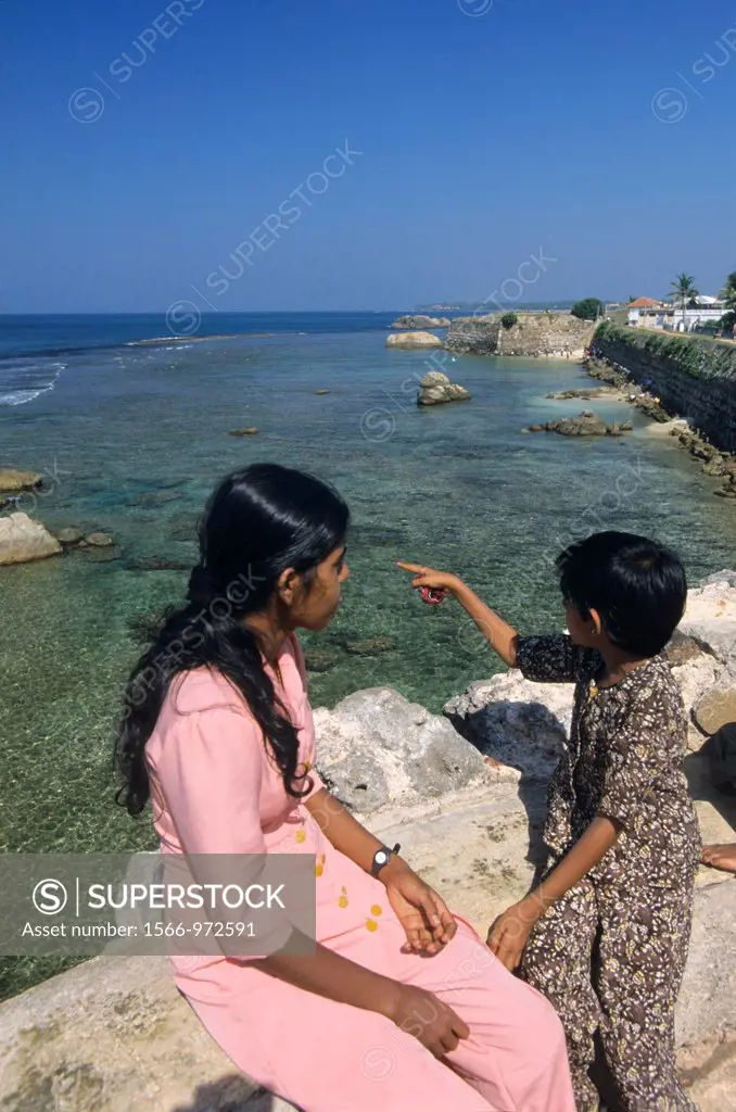Local mother and her daughter on old Fort wall, Galle , Sri Lanka