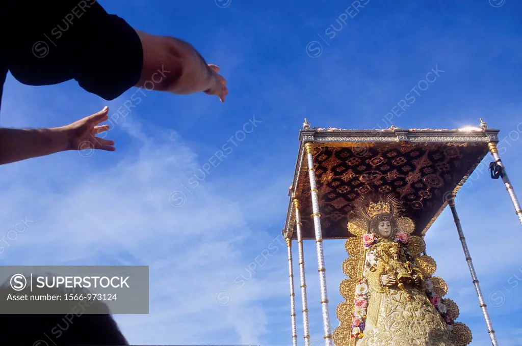 Arms of priest, he scream wishes and thanks to the virgin,Romería, pilgrimage, at El Rocío, Blanca Paloma, virgin procession, Almonte, Huelva province...
