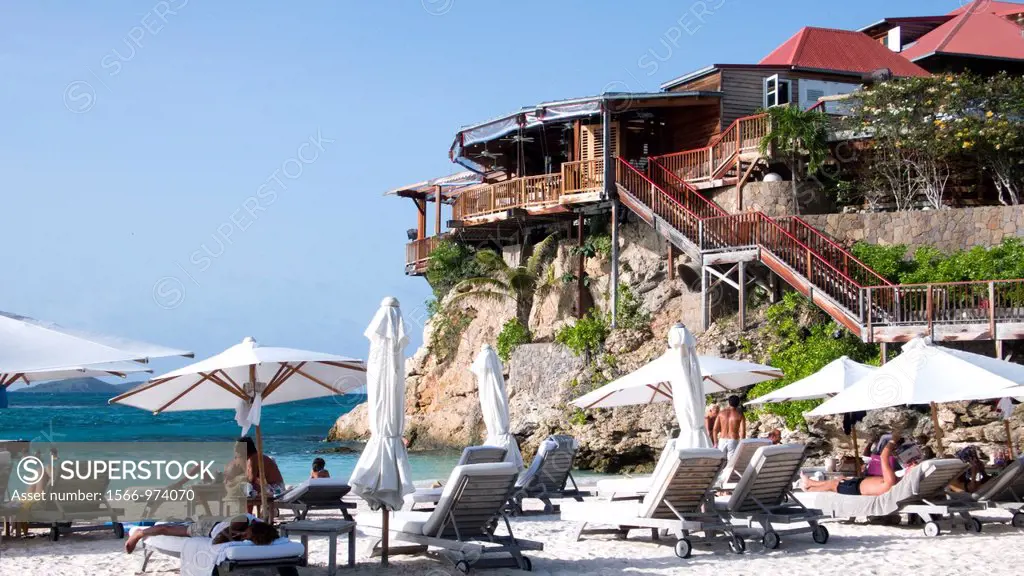 Beach umbrellas and sun loungers beside luxury Eden Rock Hotel Baie de St Jean St Barts
