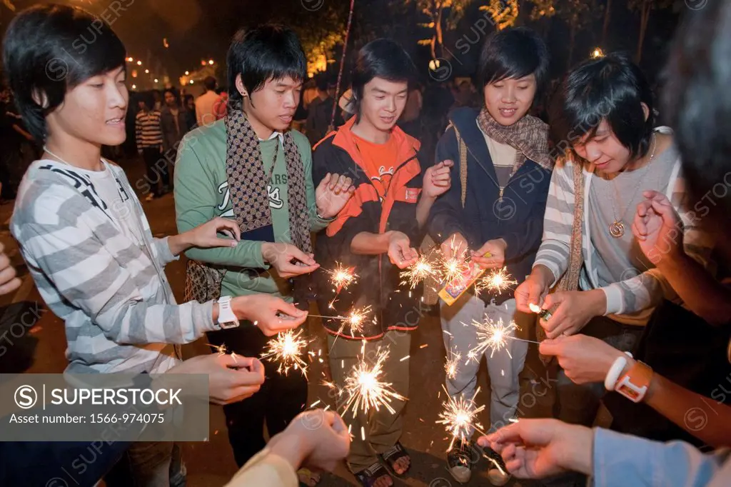 Young people light sparklers Loy Krathong festival Nawarat Bridge Chiang Mai Thailand
