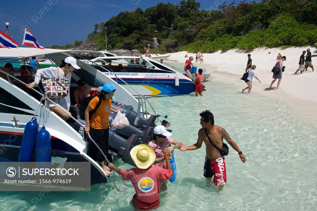 Visitors wade ashore from speed boats Similand Island Ko 8 Similan Islands Thailand