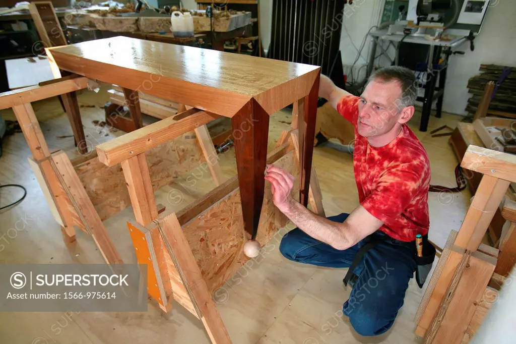 A carpenter at work He produces furniture from raw materials editorial use only, no negative publicity