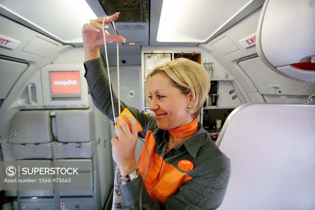 Stewardess presenting safety equipment on board editorial use only, no negative publicity