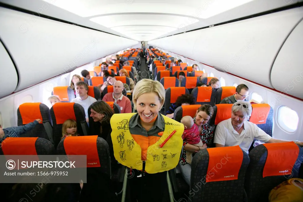 Stewardess presenting safety equipment on board editorial use only, no negative publicity