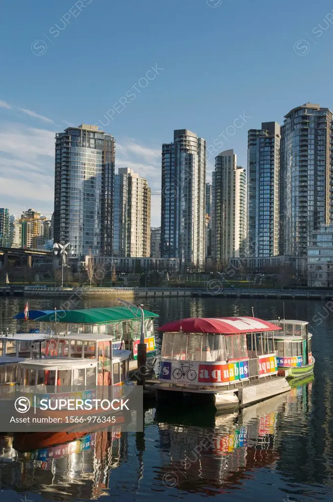 Aquabus ferry in False Creek in front of condominiums of Yaletown in downtown Vancouver British Columbia Canada