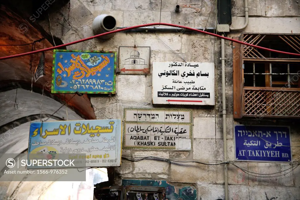 Signs hanging at a market in the old city section of Jerusalem