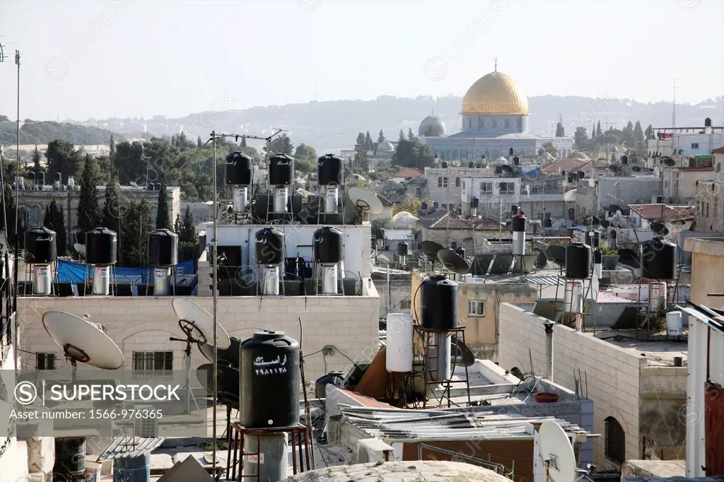 Rooftops full of chimneys and communications equipment in the old city section of Jerusalem Nearby the dome of the rock