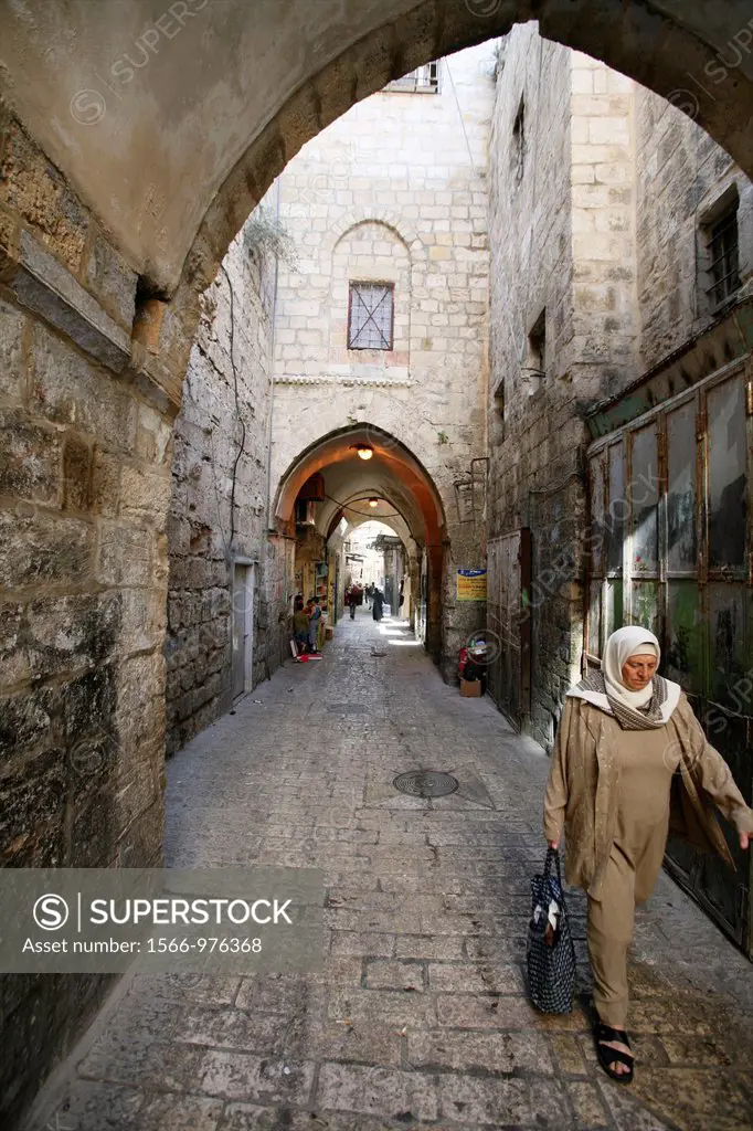 A Muslim woman walks through a market in the old city section of Jerusalem