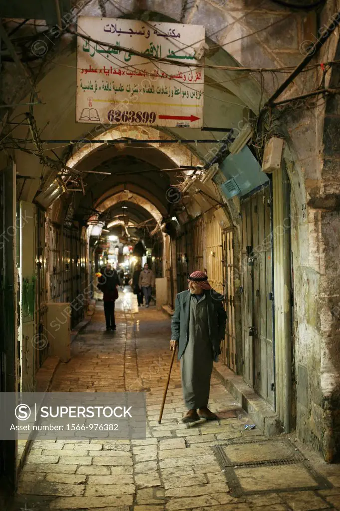 A Musliim man walks through a market in the old city section of Jerusalem